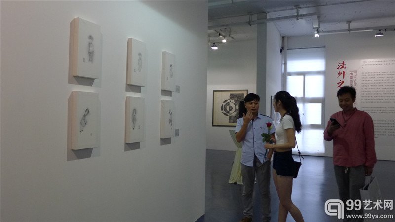 策展人叶彩宝向友人介绍作品