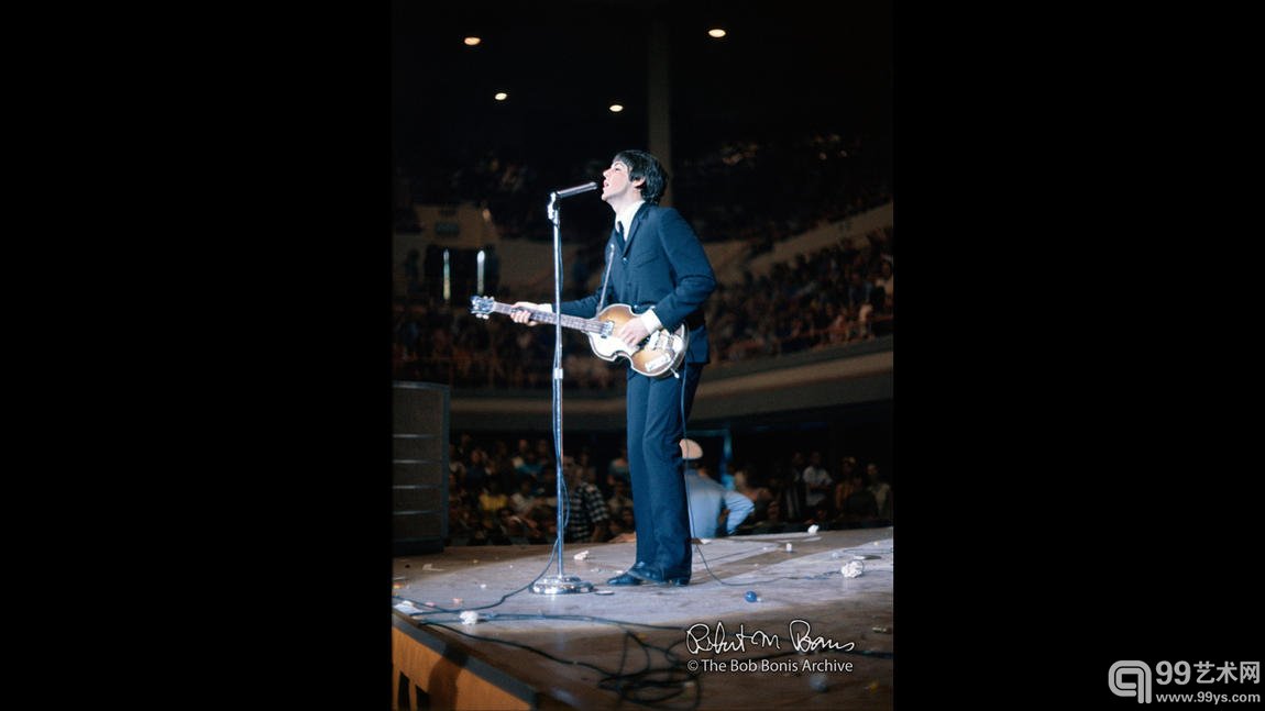 Paul McCartney on stage amidst debris, Houston, August 1965
