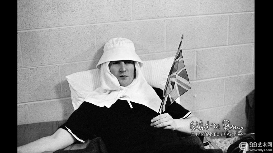 John Lennon backstage, waving the British flag, Portland, Ore., August 1965