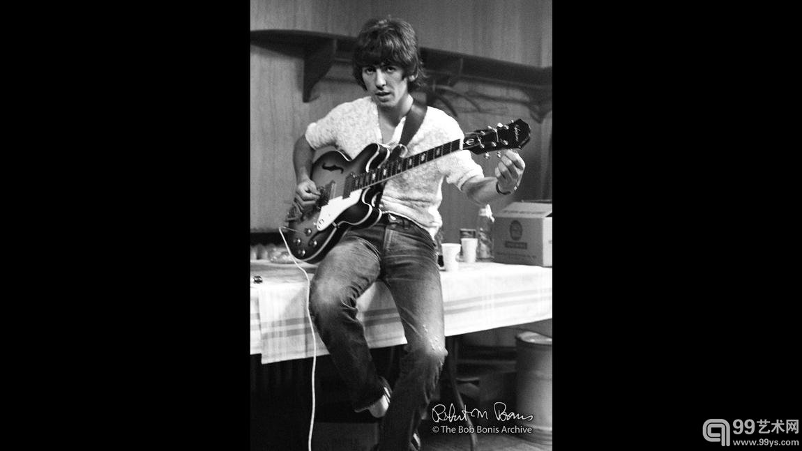 George Harrison tunes his guitar backstage, Philadelphia, August 1966