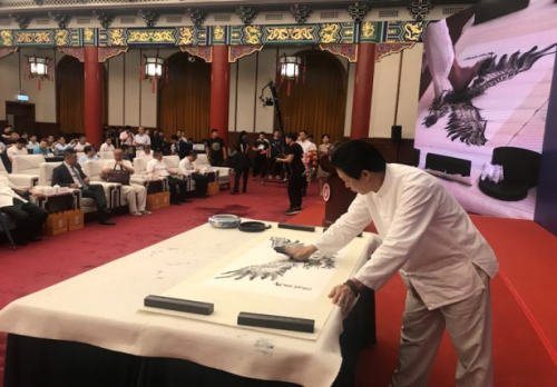 李聪扬在全国政协礼堂专注作画(贾敏/摄)