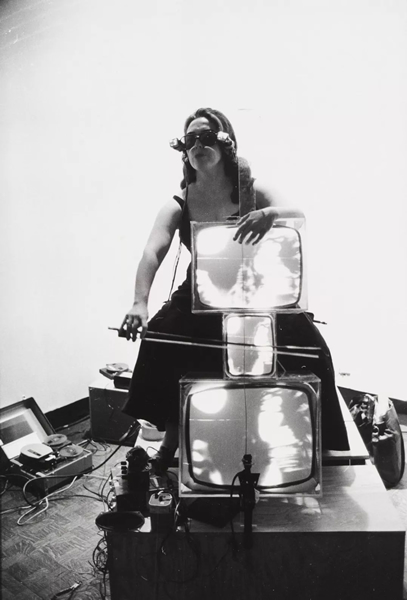 Peter Moore, Charlotte Moorman Performing Nam June Paik’s “Concerto for TV Cello and Videotapes”, 1971, gelatin silver print, framed: 10 1/4 × 16 1/4 inches (26 × 41.3 cm), Gift of Barbara Moore in memory of Peter Moore, Charlotte Moorman, and Frank Pileggi, 1994 © Barbara Moore/Licensed by VAGA, New York, NY. Courtesy Paula Cooper Gallery, New York