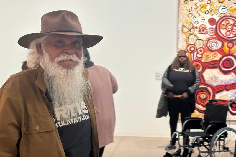 Frank Young, APY Elder, inside the Ngura Puḻka exhibition. Photo-Helen Musa